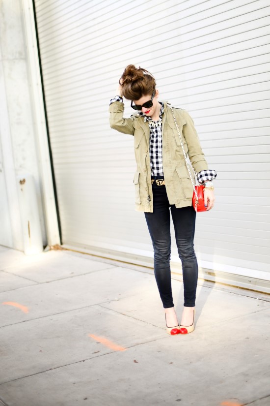 utility vest, gingham shirt, red patent leater bag, leopard belt, black jeans, nude shoes with red toe