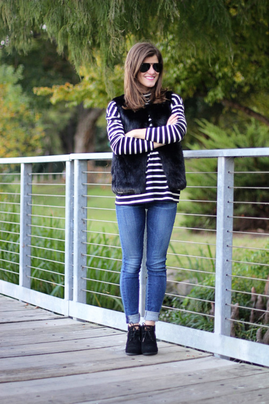 black faux fur vest and black and white striped turtleneck outfit