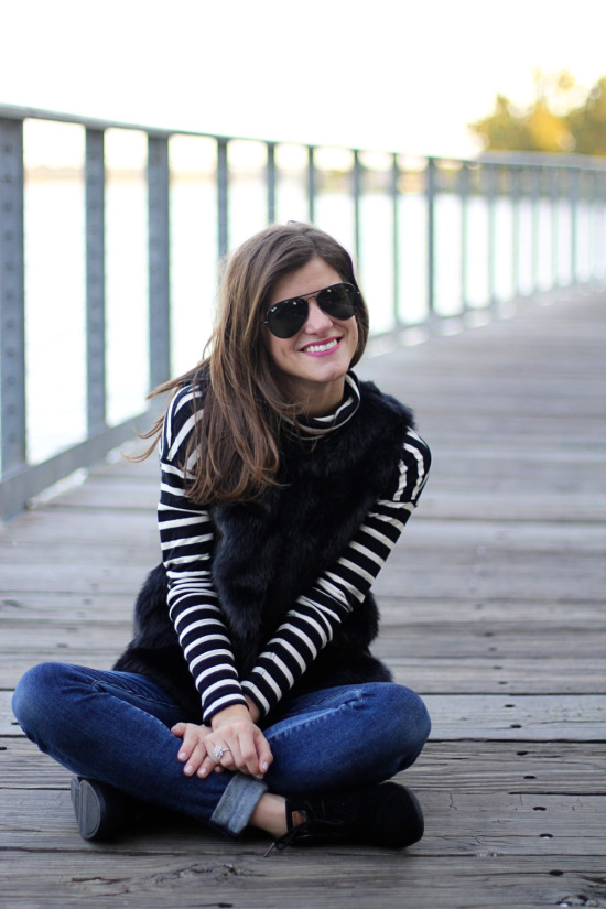 black faux fur vest and black and white striped turtleneck outfit