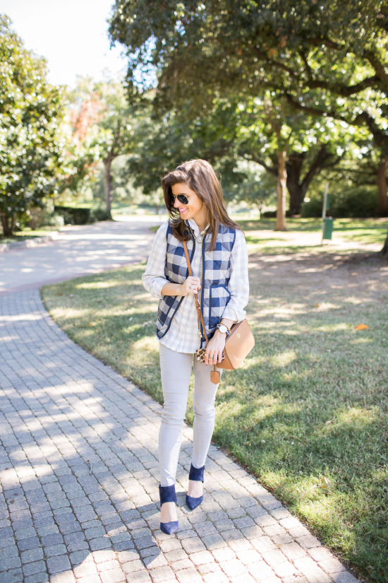 grey jeans, plaid puffer vest, grey and white check shirt, navy suede pointed toe shoes, tory burch robinson crossbdoy bag, fall outfit idea