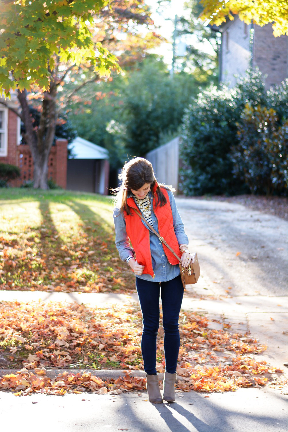 chambray shirt over striped turtleneck with puffer vest