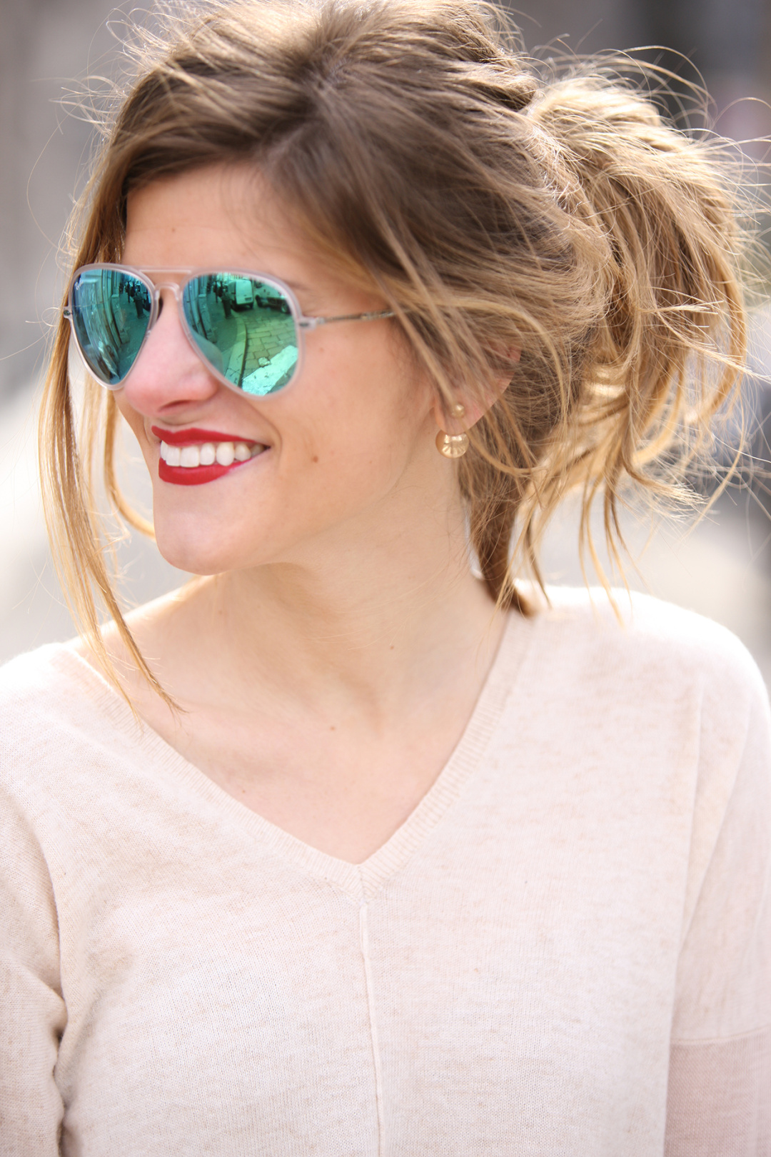 messy top knot red lips mirrored green aviators