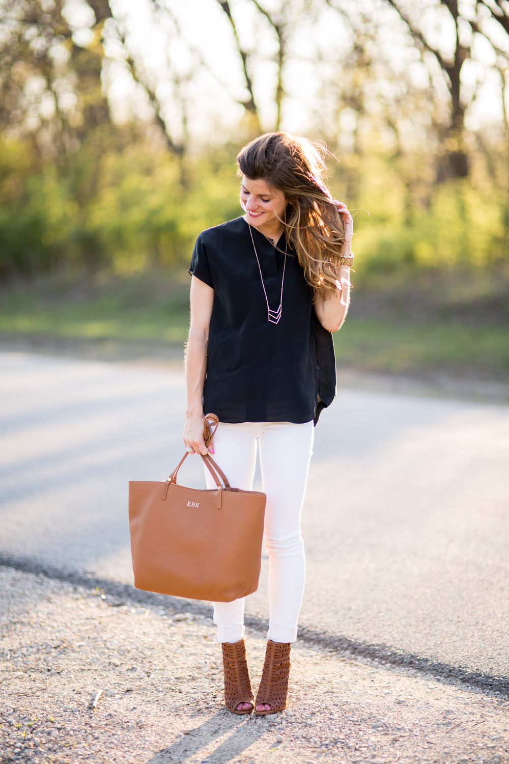 black shirt brown shoes white jeans outfit, fall outfit idea, matching bag and booties, peep toe booties outfit, black top, white jeans with black top