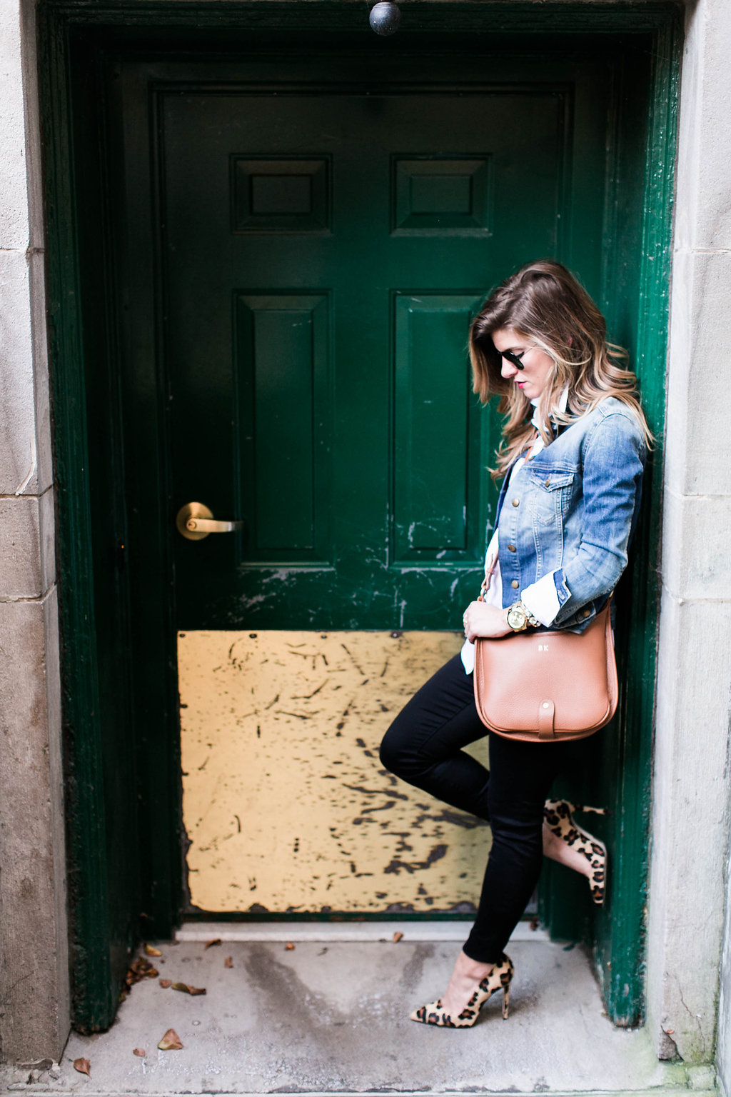 denim jacket and white button down and brown leather crossbody and leopard pointed toe heels