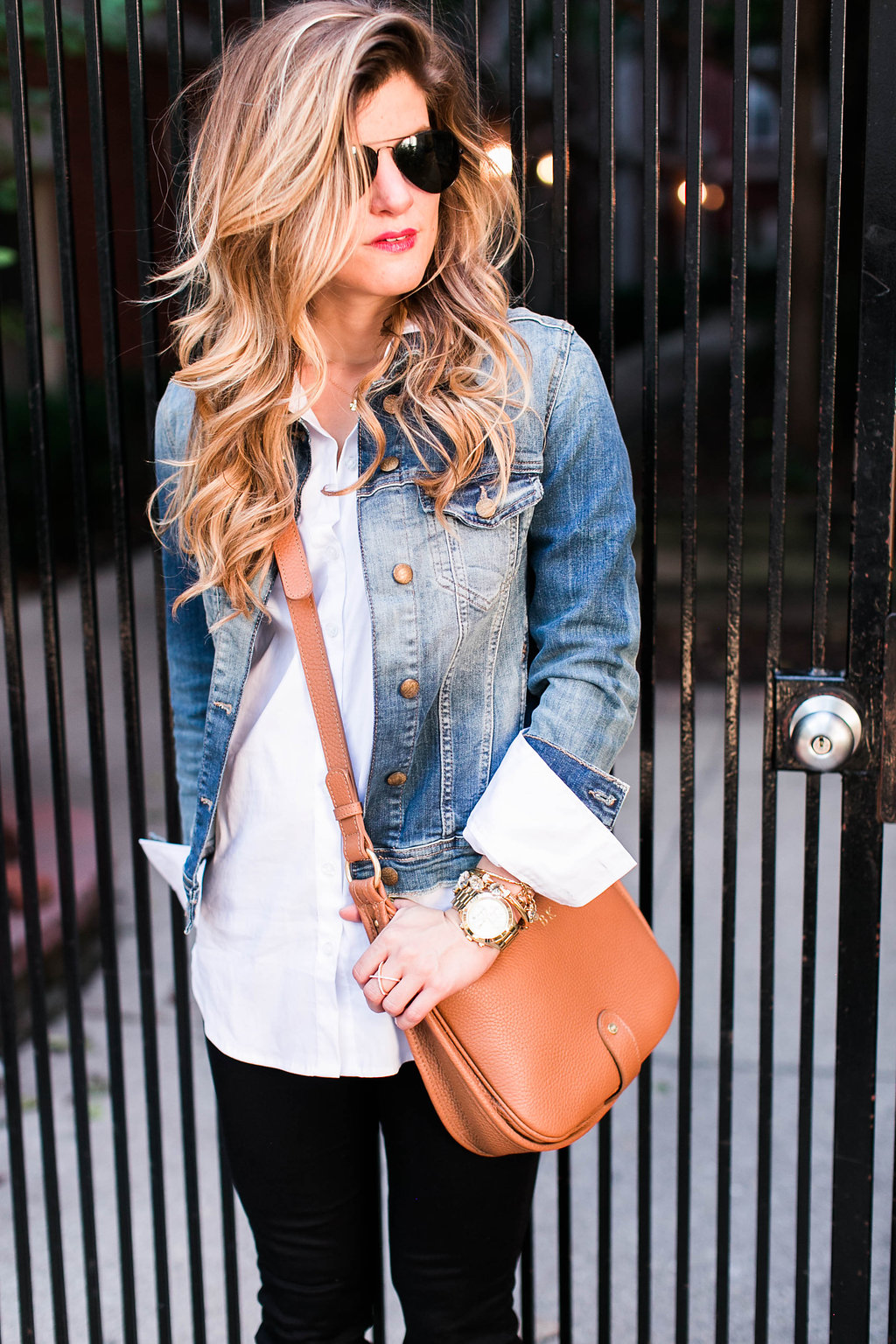 denim jacket and white button down and brown leather crossbody