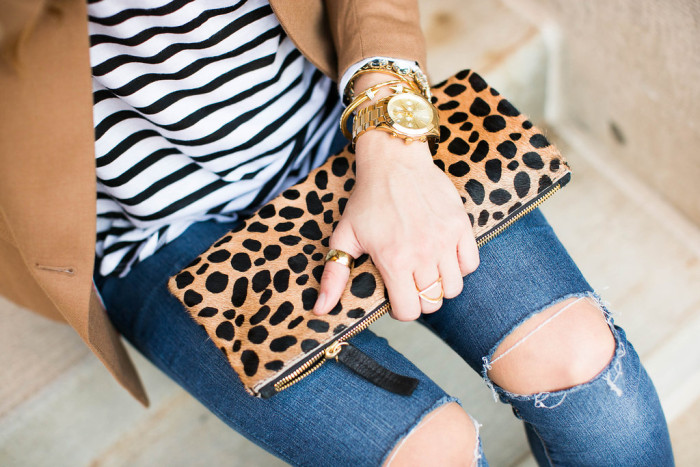 clare vivier leopard clutch and black and white stripes close up