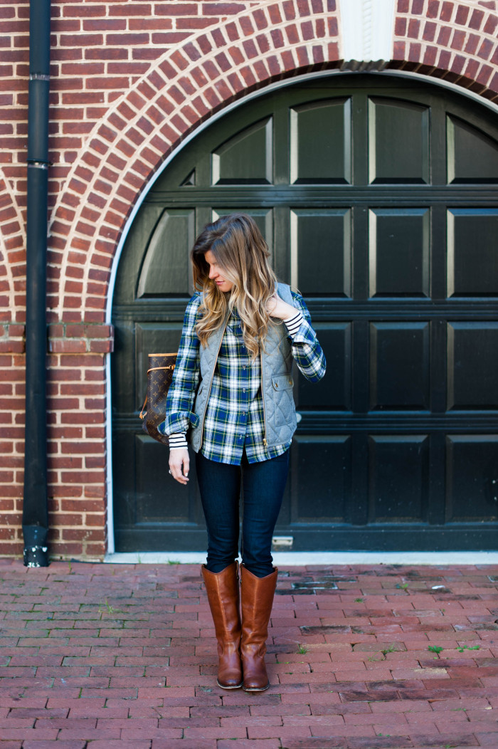 layered stripes and plaid under a puffer vest