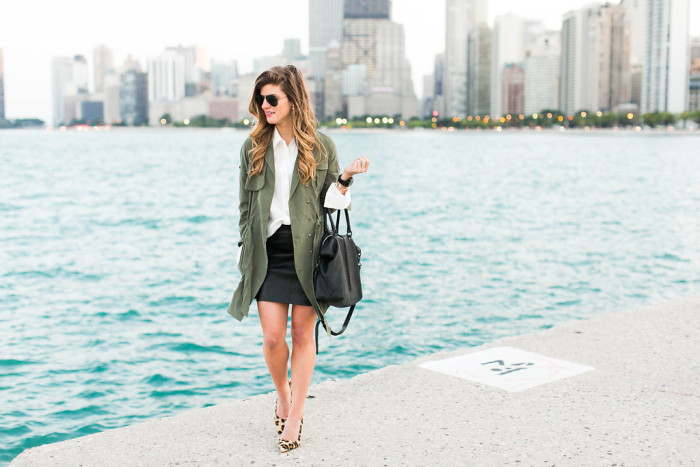 fall outfit featuring black leather mini skirt and white blouse with olive green jacket and leopard heels