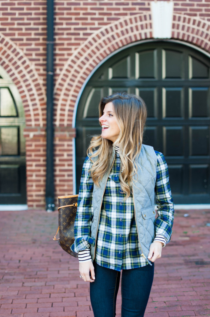 layered stripes and plaid under a puffer vest