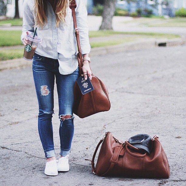Travel Outfit with Jeans and button down and brown leather duffell bag