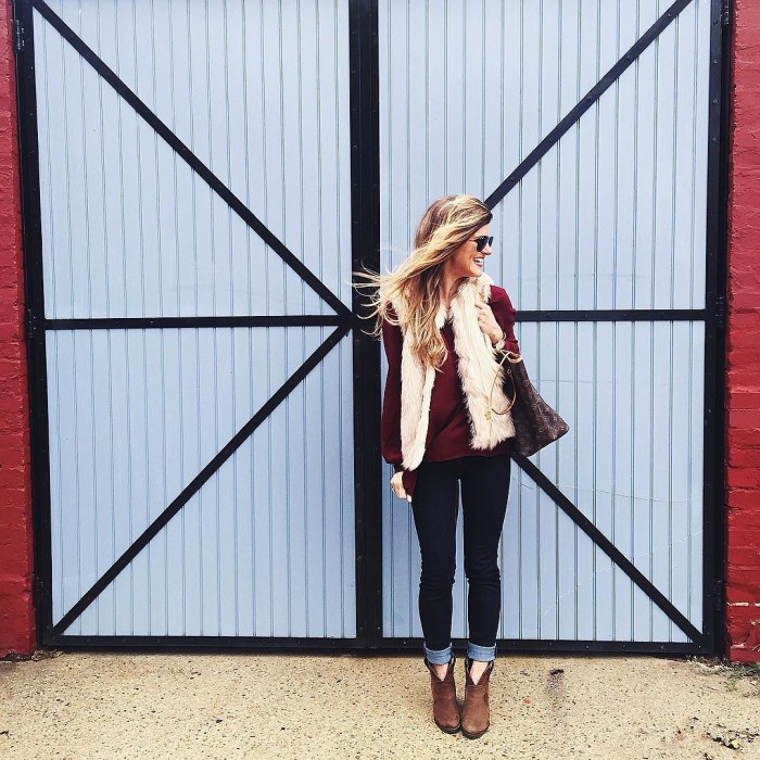 faux fur vest and burgundy top with jeans and booties