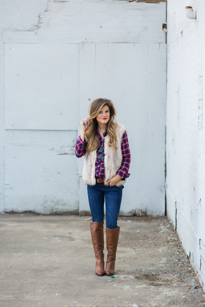 plaid button down and faux fur vest with brown tall boots