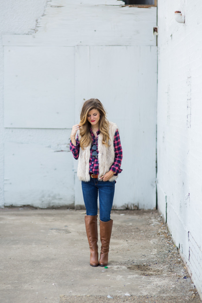 plaid button down and faux fur vest with brown tall boots