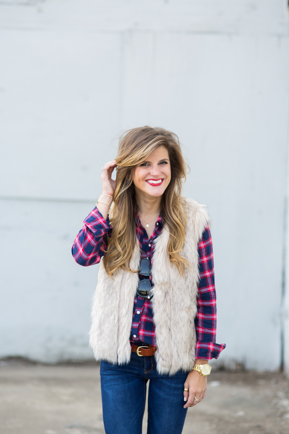 plaid shirt and a fur vest and red lips fall style outfit