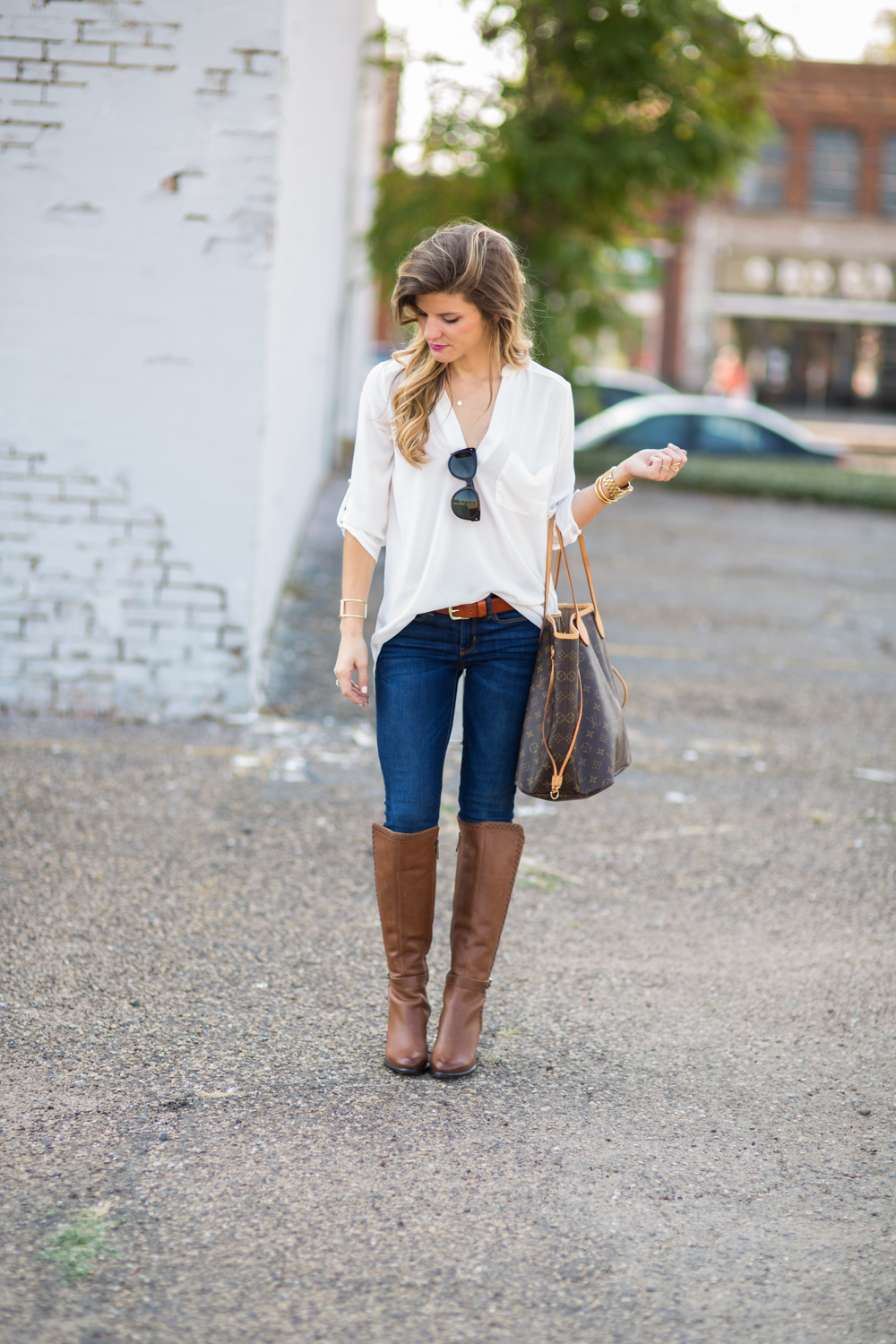 white jeans tan boots navy sweater louis vuitton — bows & sequins