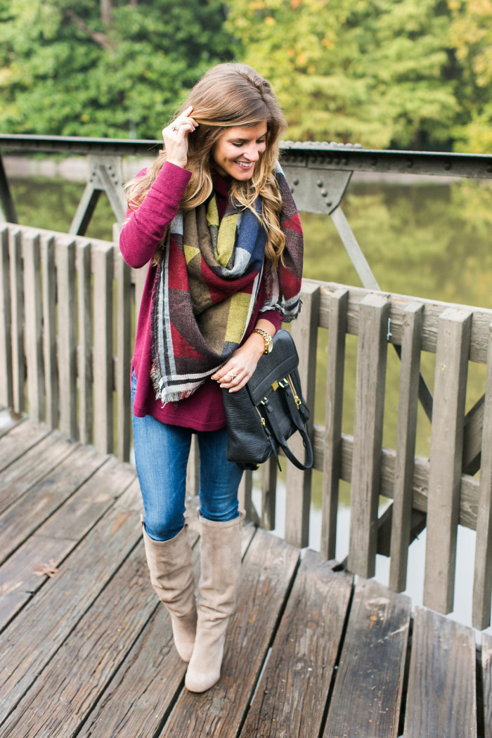 Fall outfit with blanket scarf, burgundy turtleneck, jeans, tall boots