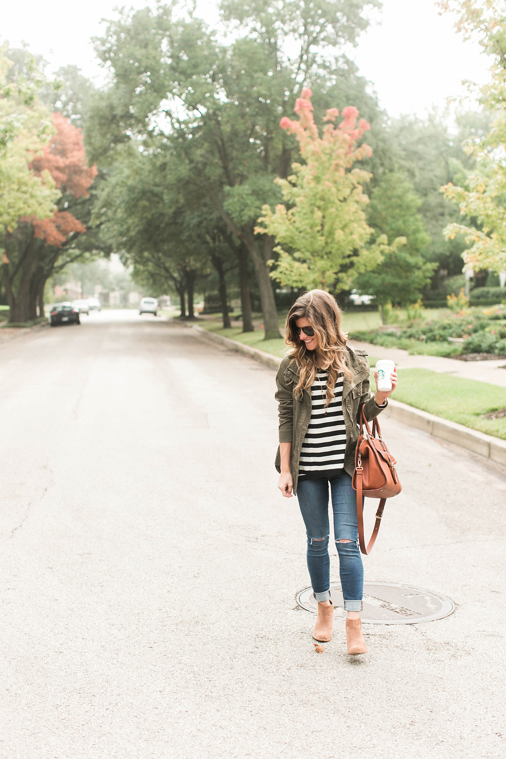 black and white stripes and utility jacket and coganc booties and brown bag