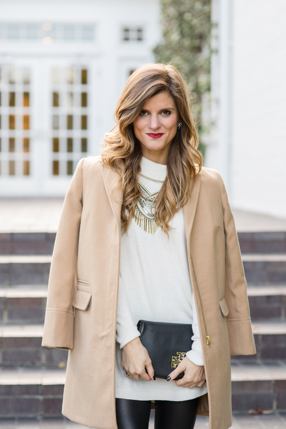 date night outfit with cream turtleneck camel topshop coat tory burch convertible clutch red stila lip stain baublebar statement necklace