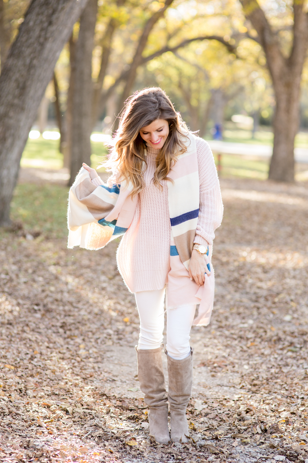 how to wear white jeans after labor day - white jeans outfit, oversized pastel pink sweater, striped scarf, suede knee high boots