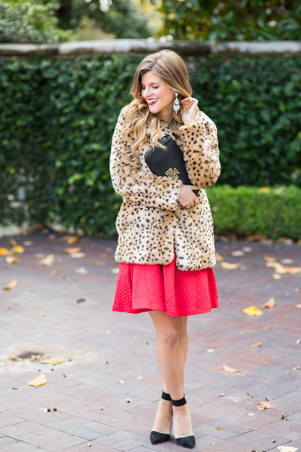 festive holiday party outfit - faux fur leopard coat over red dress for a holiday party