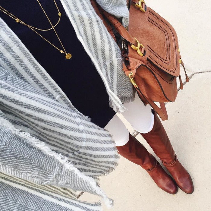 selfie photo with grey poncho wrap, navy sweater, layering necklaces, riding boots and chloe bag
