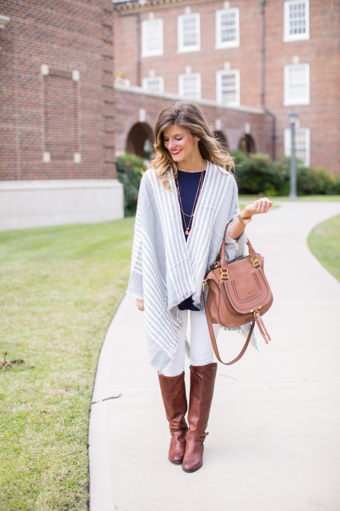 Grey poncho white jeans and brown riding boots