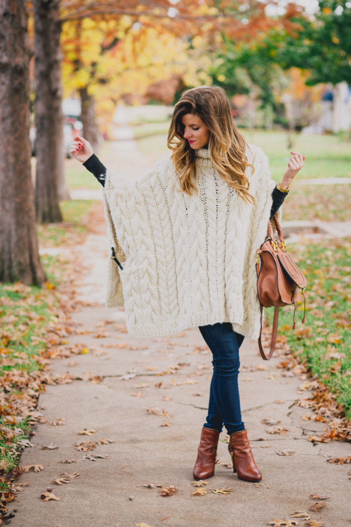 cable knit poncho outfit with jeans and cognac leather booties