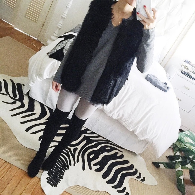 black faux fur vest, grey sweater, light grey skinny jeans, black over the knee flat boots, brighton keller mirror selfie instagram
