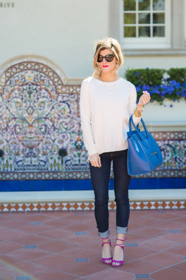 Brighton the day wearing white sweater with dark blue skinny jeans and hot pink sandals