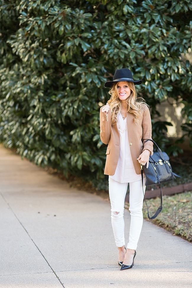 brighton wearing camel blazer with pink blouse and white distressed skinny jeans for an all neutral outfit 