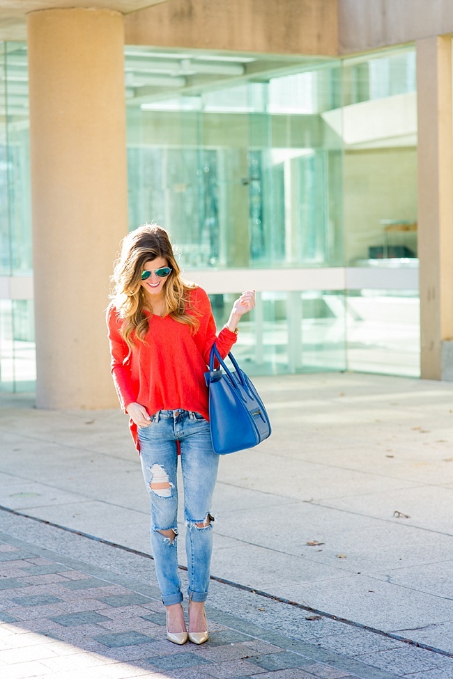 brightontheday wearing ripped jeans, bright orange sweater, green mirror aviator sunglasses, nude pointed toe pumps