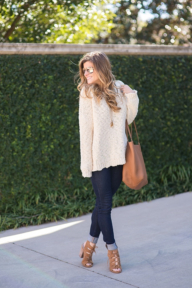 Brightontheday in a oversized cream sweater and dark wash jeans combo paired with cognac accessories 