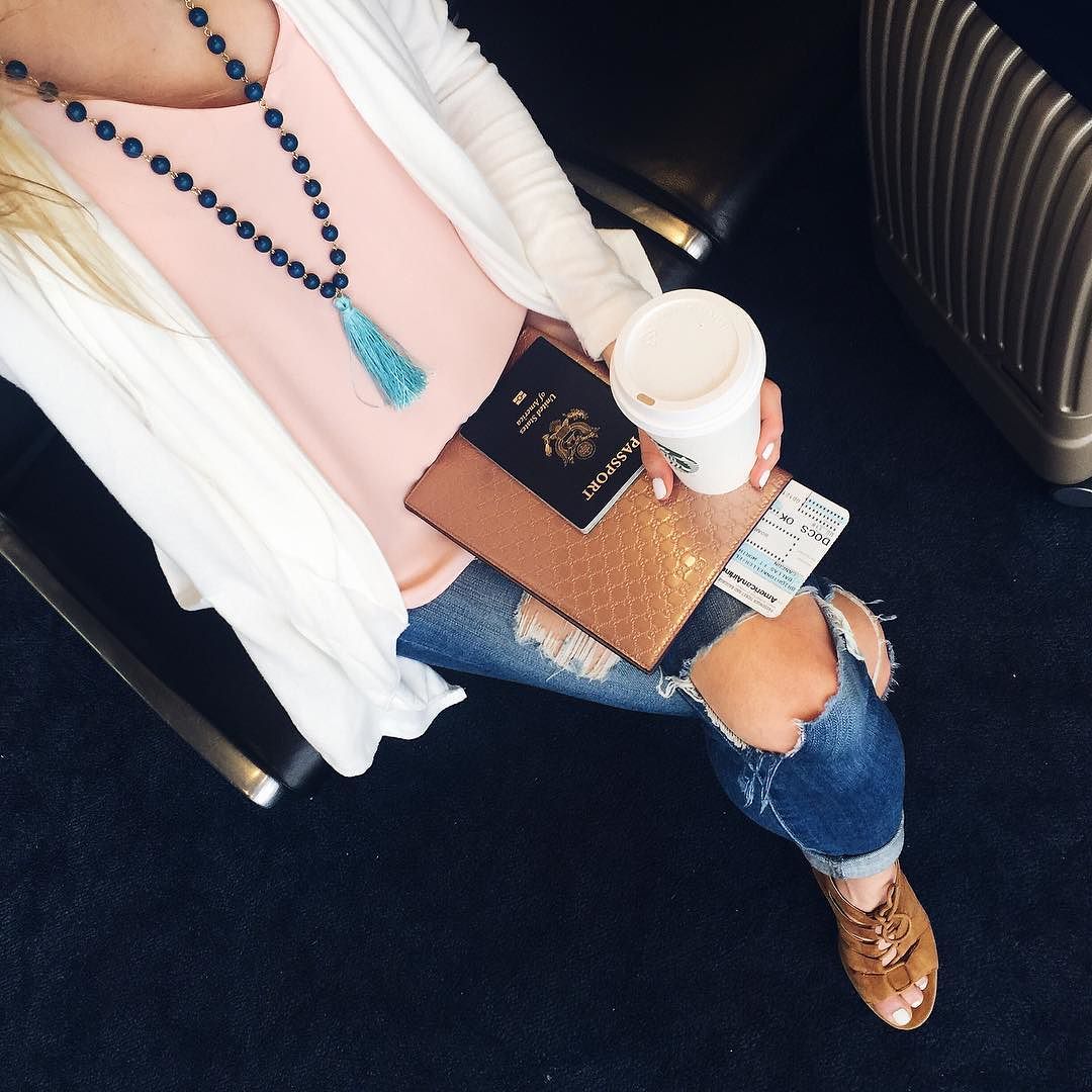 brightontheday travel outfit wearing pink tank, tassel necklace, distressed jeans and neutral wedges