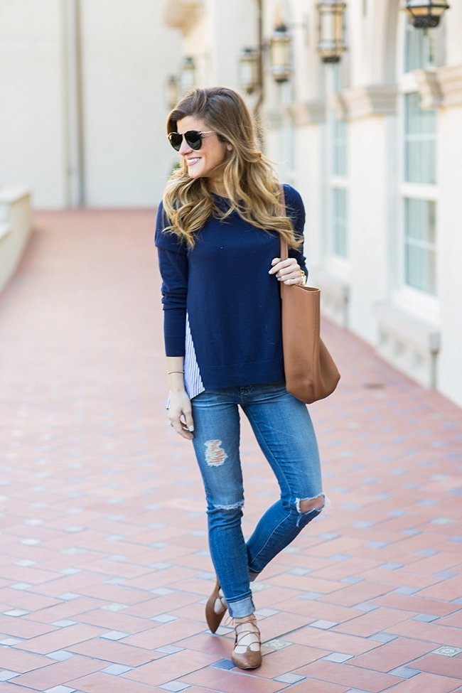 Brighton wearing halogen blue sweater with distressed denim and tan lace up shoes 