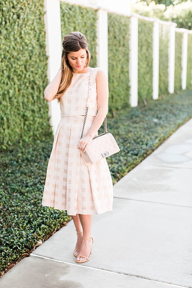 Brighton the day wearing check midi skirt with blush chanel bag 