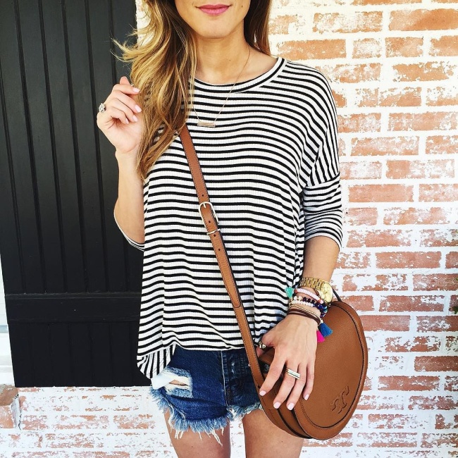 brightontheday pairing striped shirt with distressed cut off shorts and tory burch cross body 