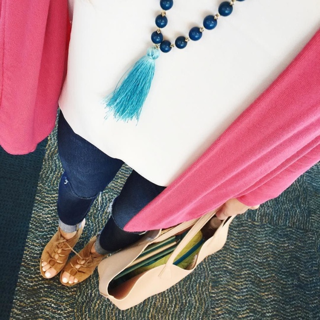 Brightontheday above shot of pink cardigan and distressed jeans outfit with blue tassel necklace