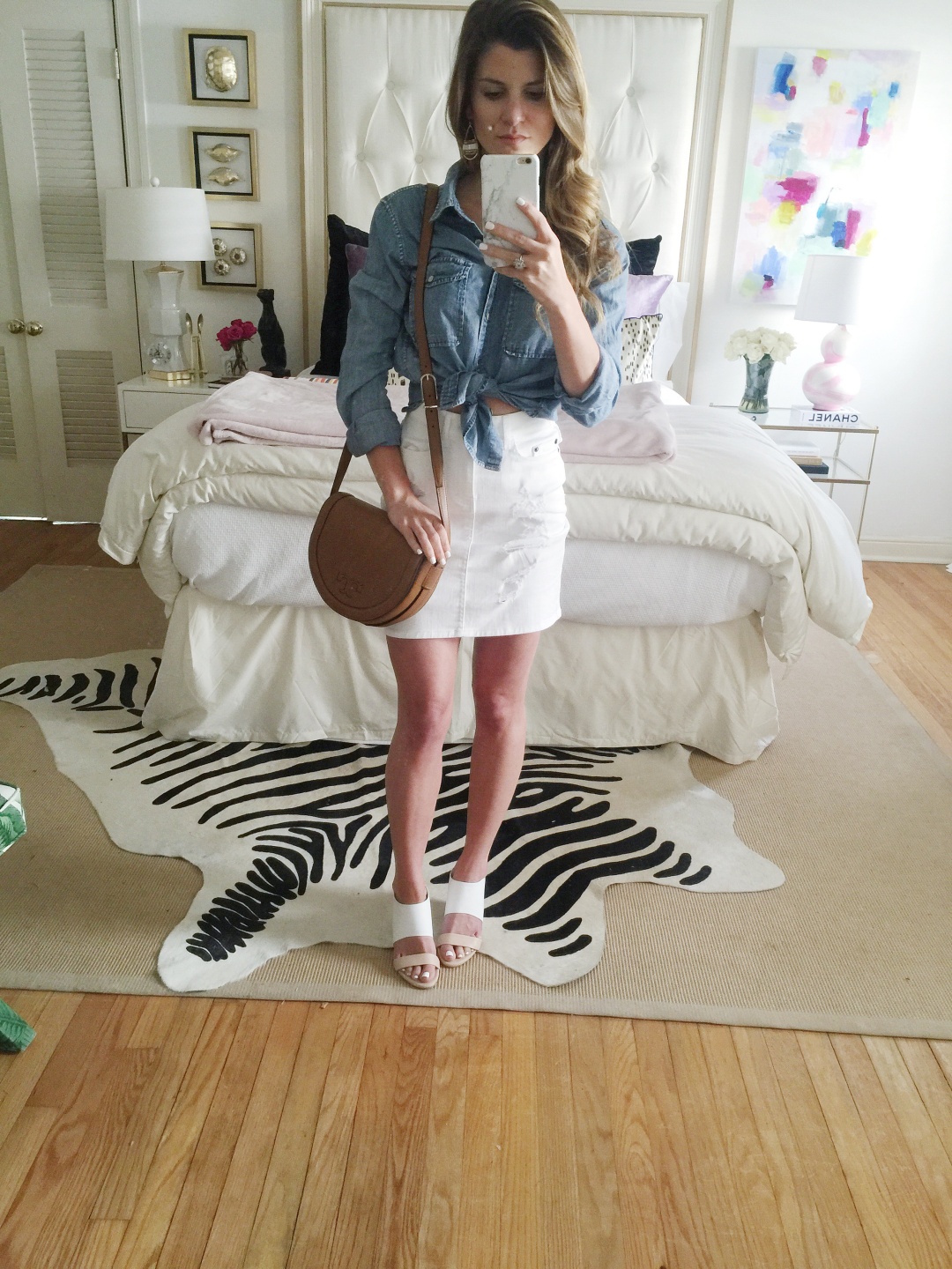 @brightonkeller wearing high-waisted mini skirt with tied up chamnray mirror selfie