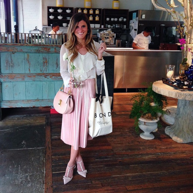@brightonkeller at forty five ten dallas wearing blush pink pleated midi skirt and ruffled blouse crop top with kate spade heels