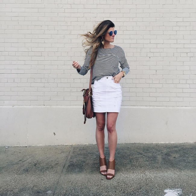 brighton the day wearing high-waisted distressed white mini skirt with a striped long-sleeved tee and cognac wedges