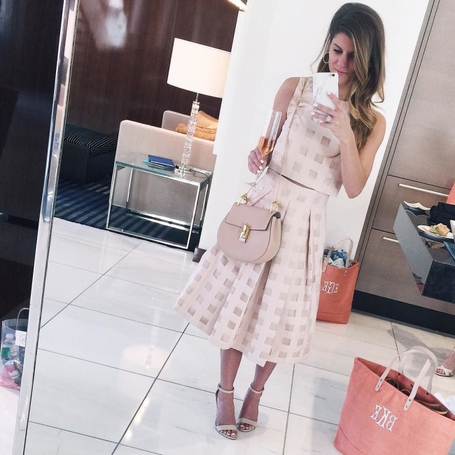 @brightonkeller wearing blush colored matching crop top and midi skirt for Spring wedding