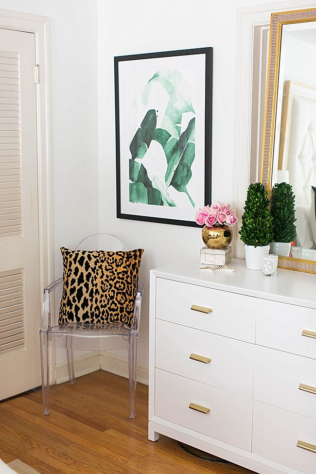 brighton keller bedroom corner detail with acrylic chair, leopard pillow, palm leaf beerly print