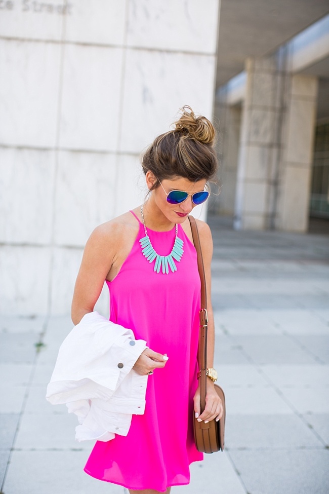 Brighton the day wearing hot pink swing dress with statement necklace 