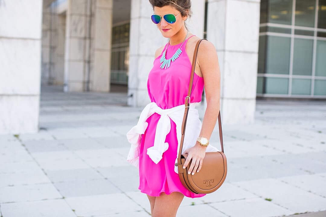 Brighton the day wearing pink everly dress with white jacket and Tory Burch Crossbody