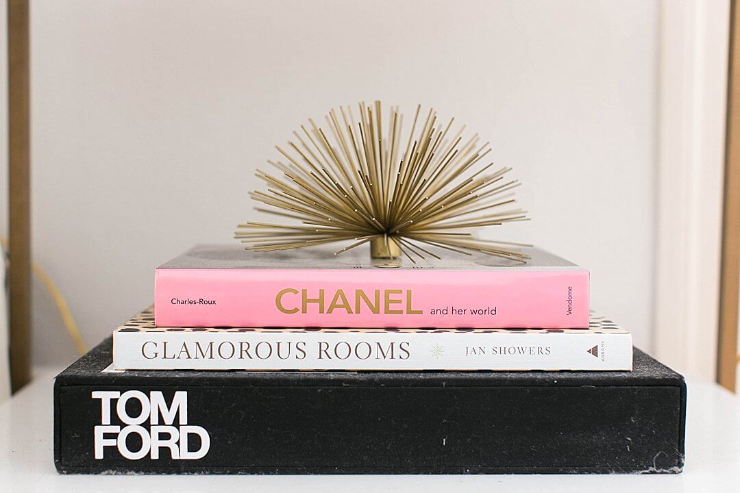 brighton keller bedroom details tom ford, glamorous rooms, chanel coffee table books with gold urchin