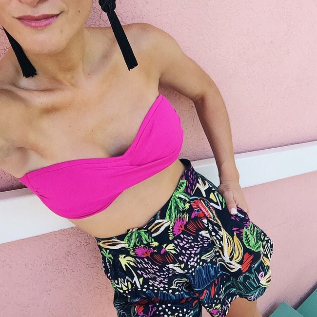 brightonkeller instagram hot pink bandeau with high-waisted printed shorts and black tassel earrings