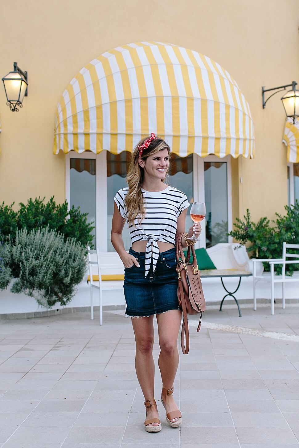 brighton keller wearing denim mini skirt with striped, cropped tie-front tee and espadrilles