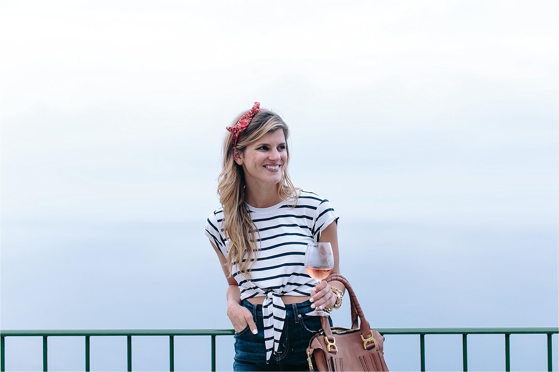 brighton keller wearing lovers and friends striped tie front crop top with red bandana hair tie