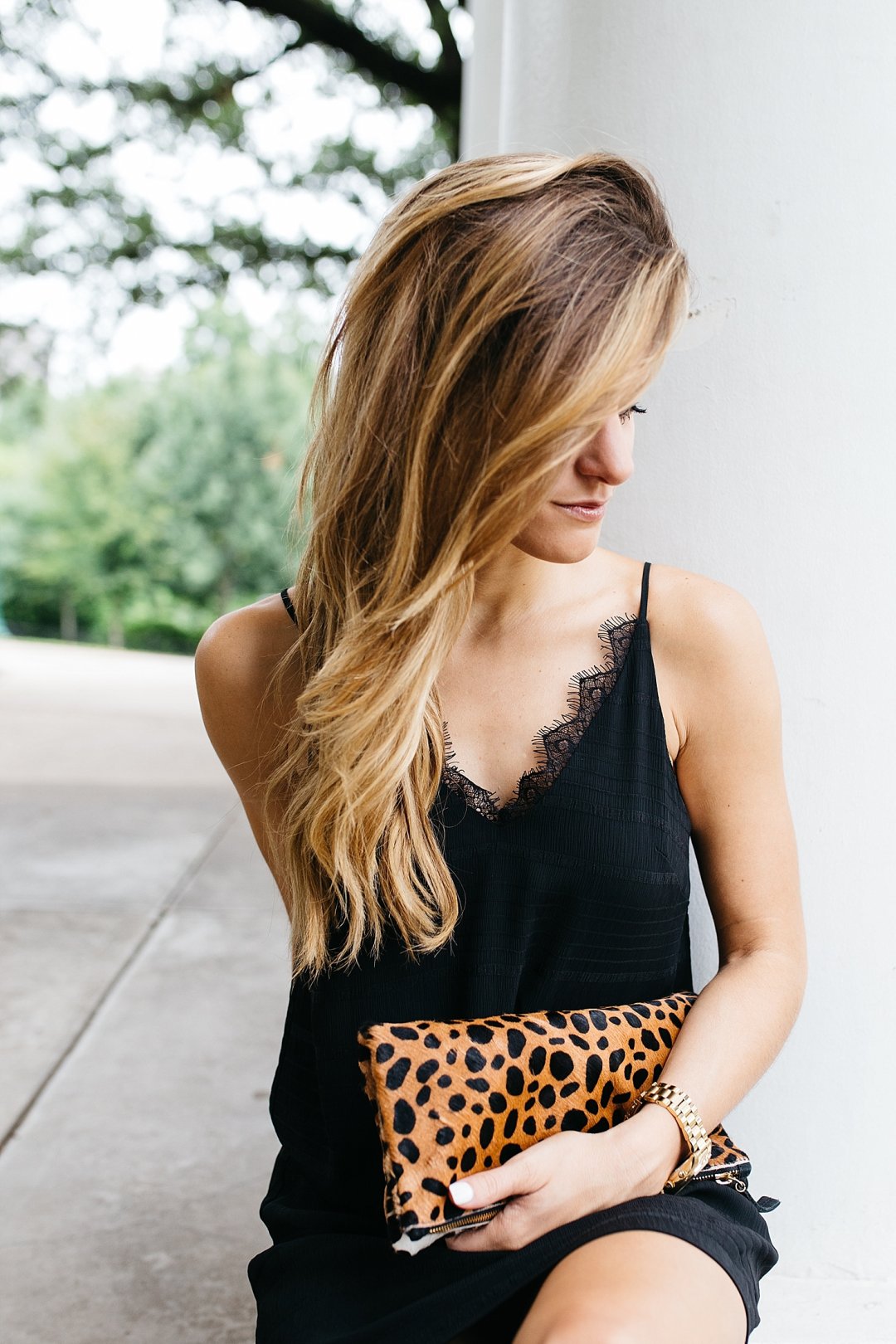 All about my hair extensions // wearing a little black slip dress with a leopard print clutch // summer going out outfit // wearing black and brown together for summer
