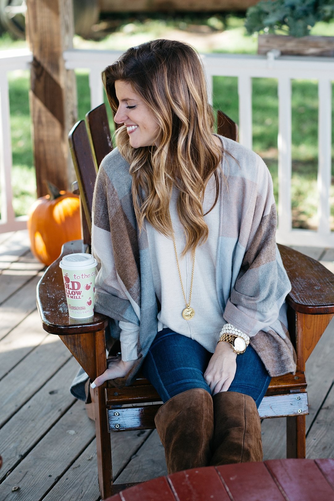 Close up at cold hollow cider mill wearing nordstrom cape and julie vos necklace with boots
